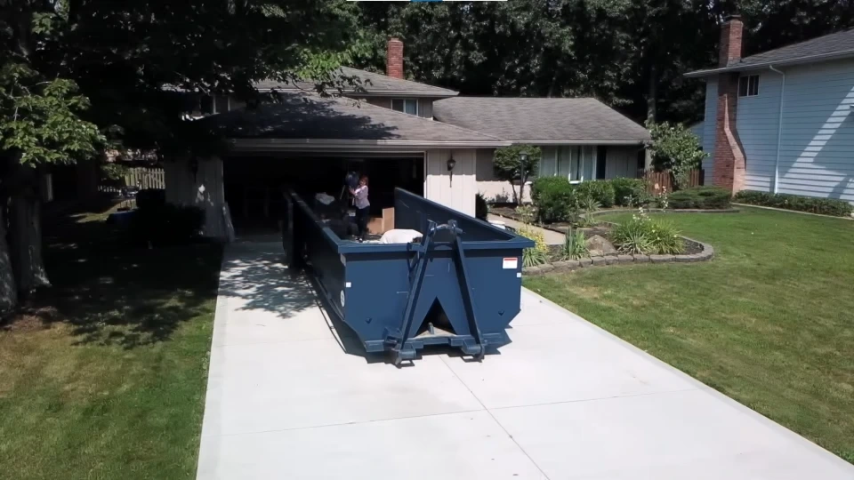 Construction debris and building materials loaded inside a dumpster