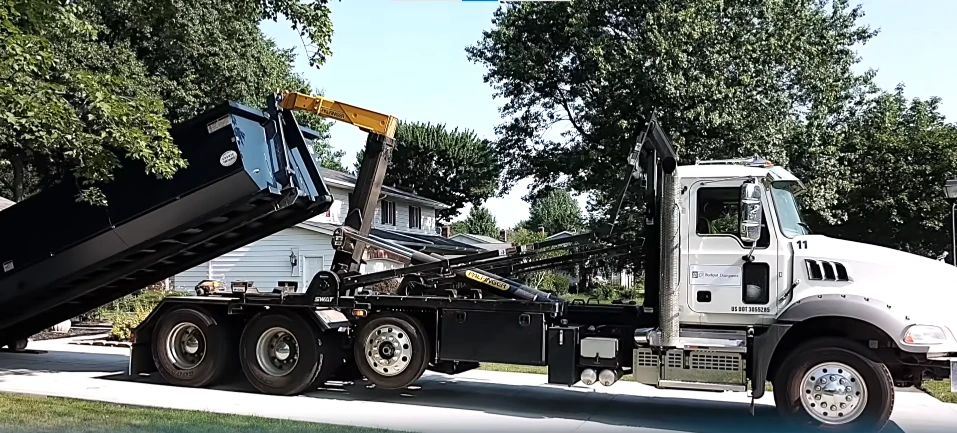 Dumpster loaded onto a trailer for transport
