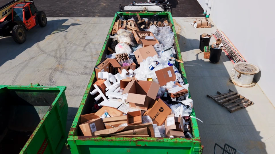 A dumpster filled with cardboard boxes and household items in Owensboro KY